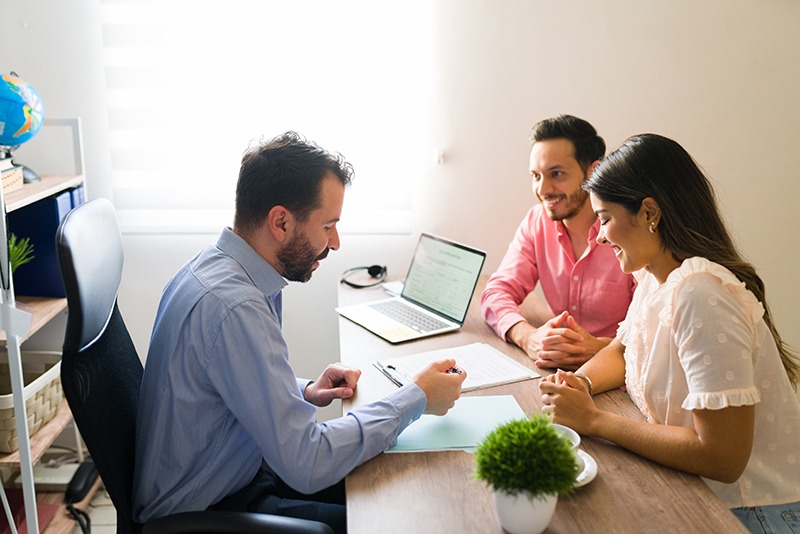 Mortgage & Finance Services couple buying flights with a sales agent